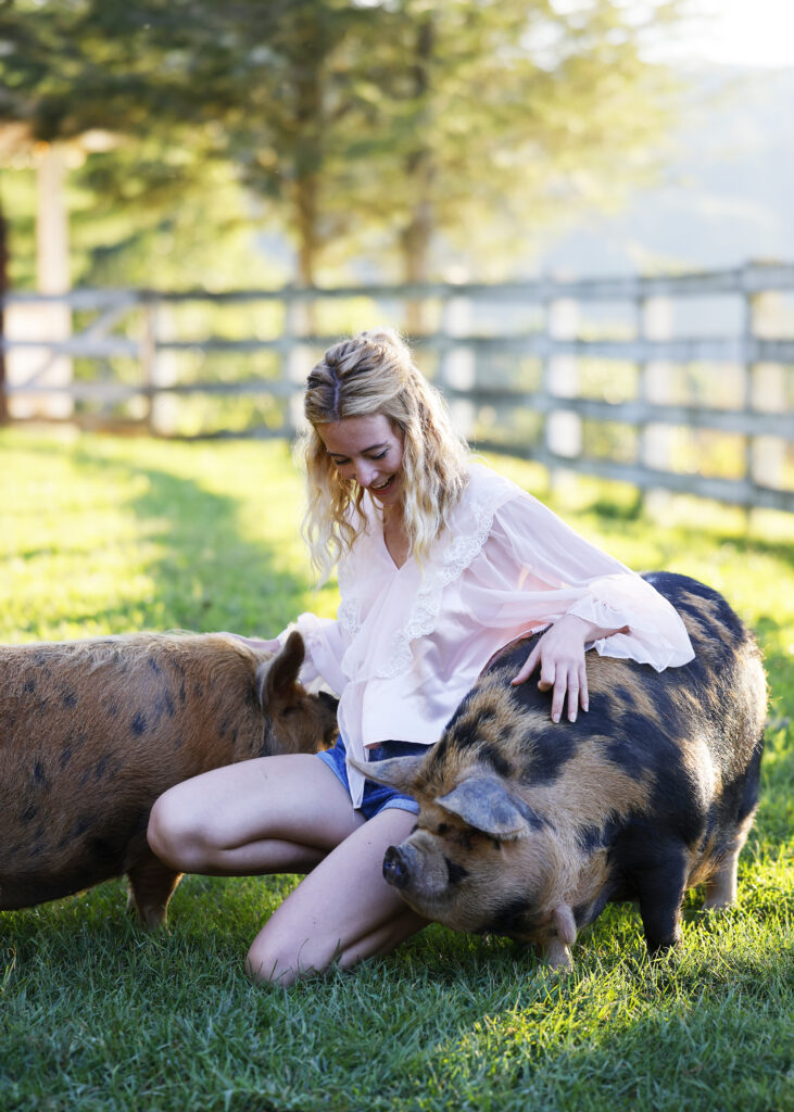 Woman petting two pigs