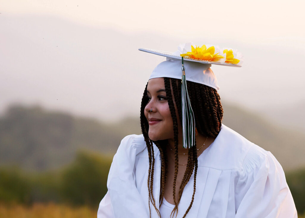 High school senior wearing a sunflower cap photographed at a North Carolina farmstay